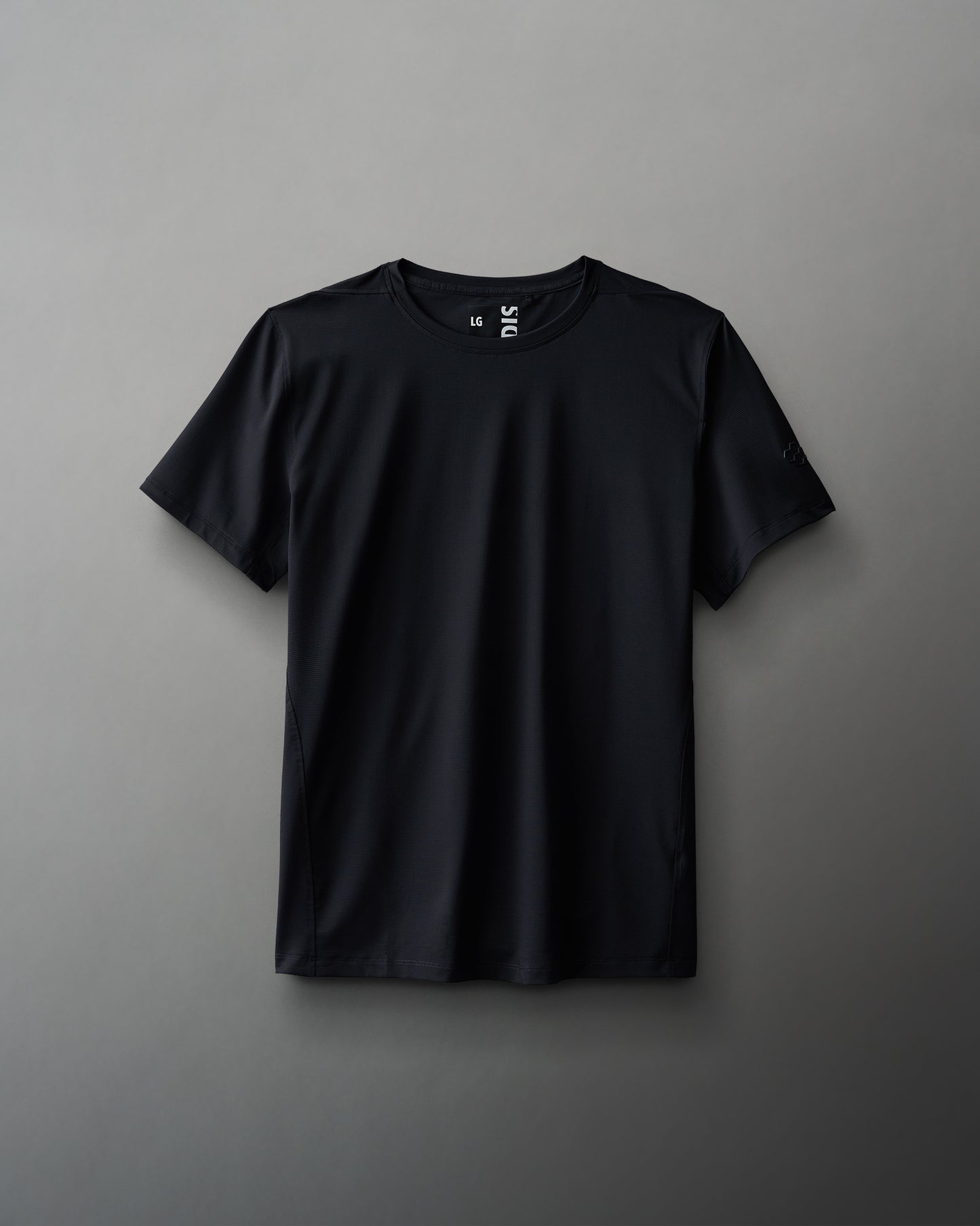 A black textured waffle material t-shirt displayed against a neutral background.