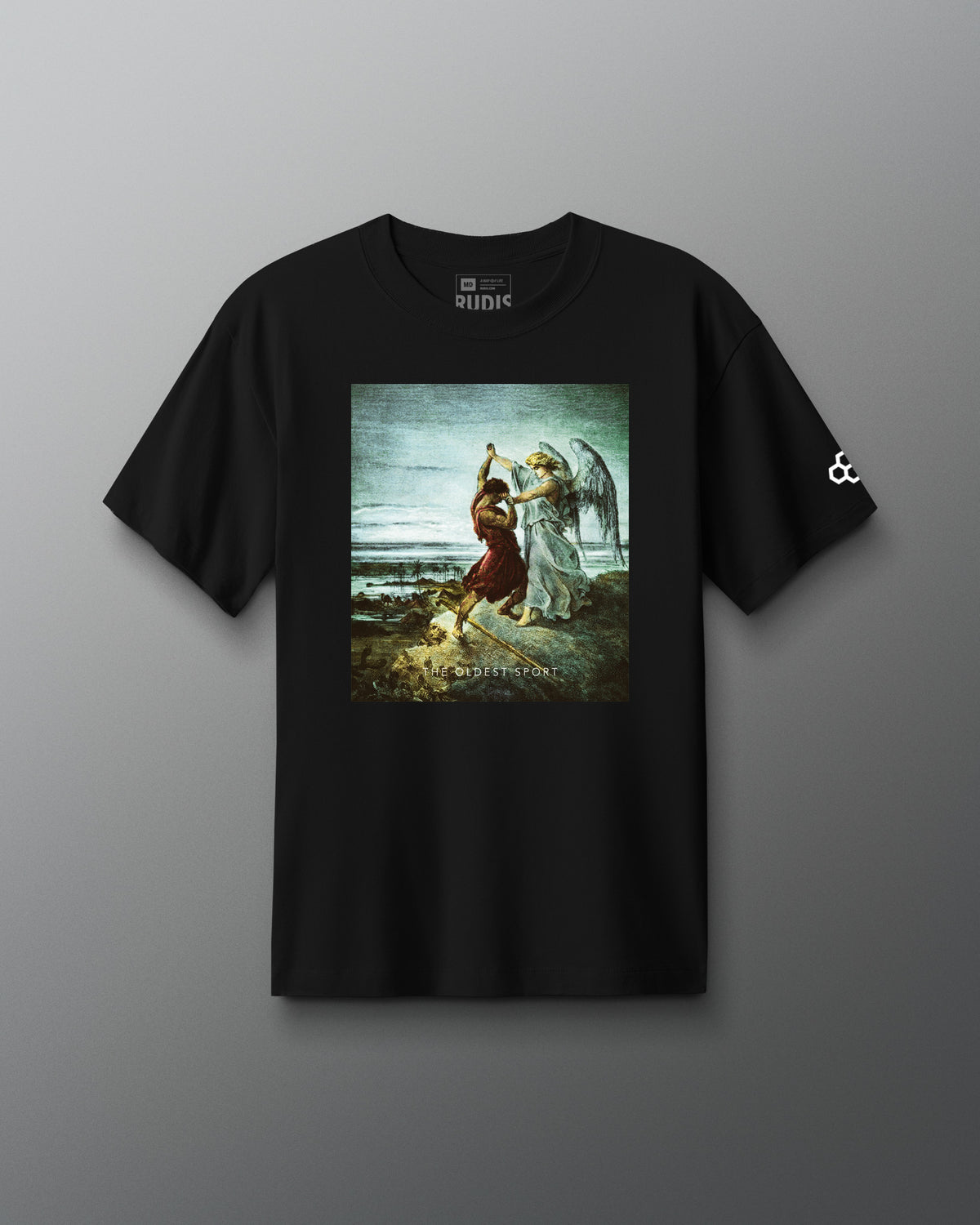 A black short-sleeve t-shirt is displayed against a gray background. Centered on the chest is a vivid artwork depicting Jacob wrestling an angel, set against a cloudy sky and landscape. Below the image, the words “THE OLDEST SPORT” appear in small white text. The shirt features a classic crewneck cut with the RUDIS logo printed inside the collar.