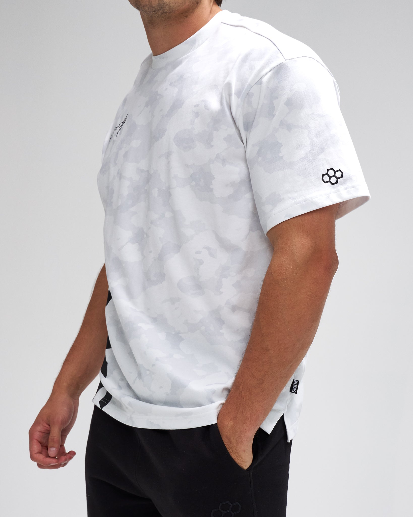 Person wearing a white t-shirt with black logo on a plain background