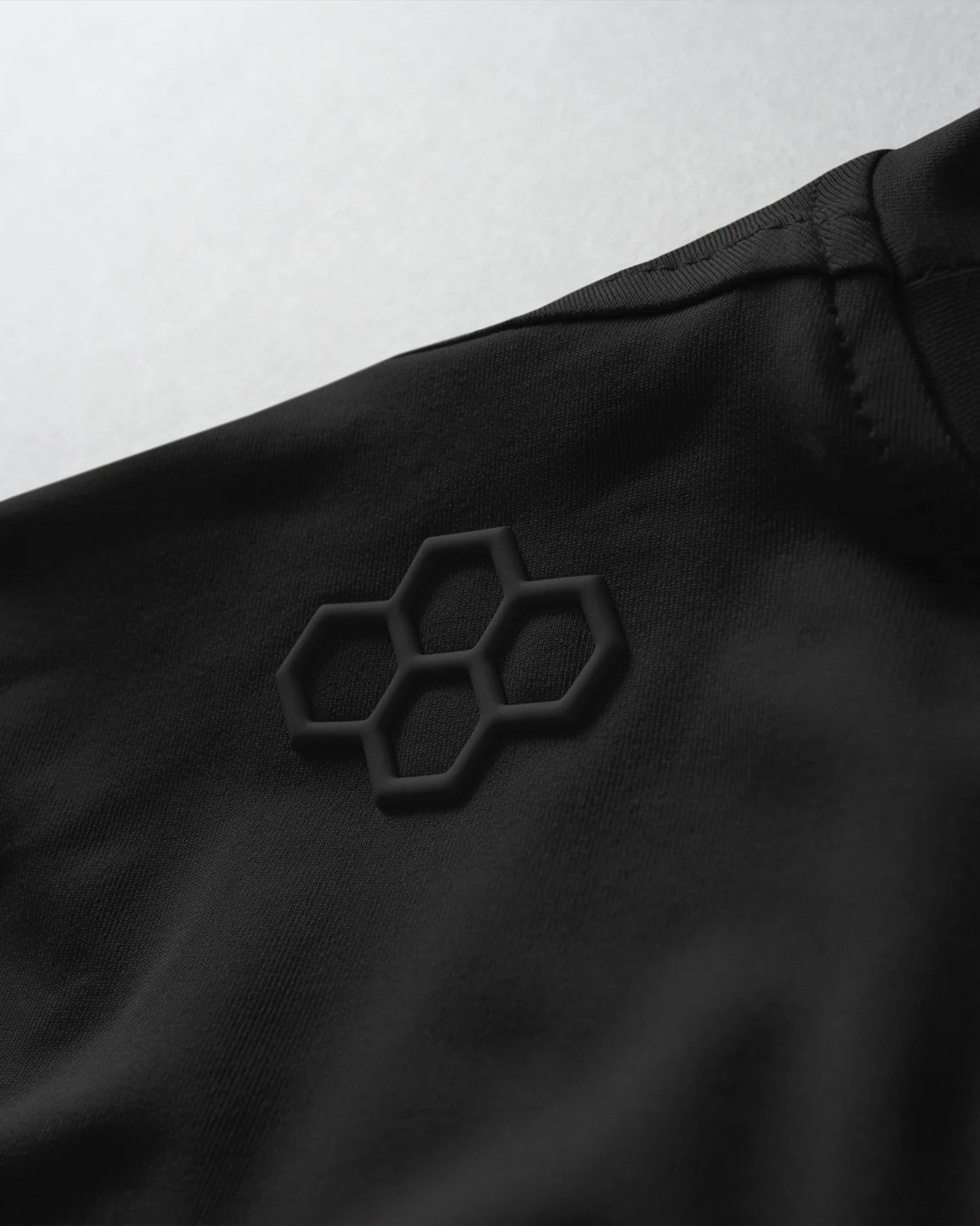 Black fabric with a honeycomb pattern on a white background