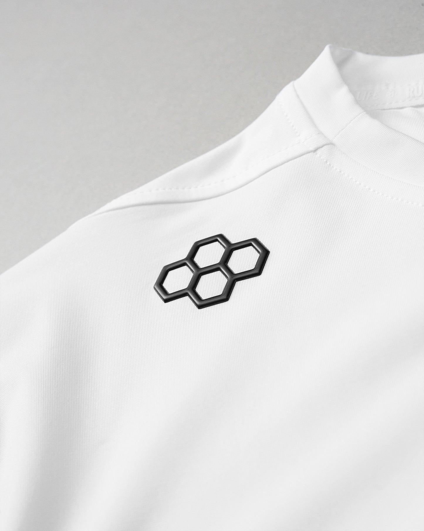 White shirt with black geometric design on a gray background
