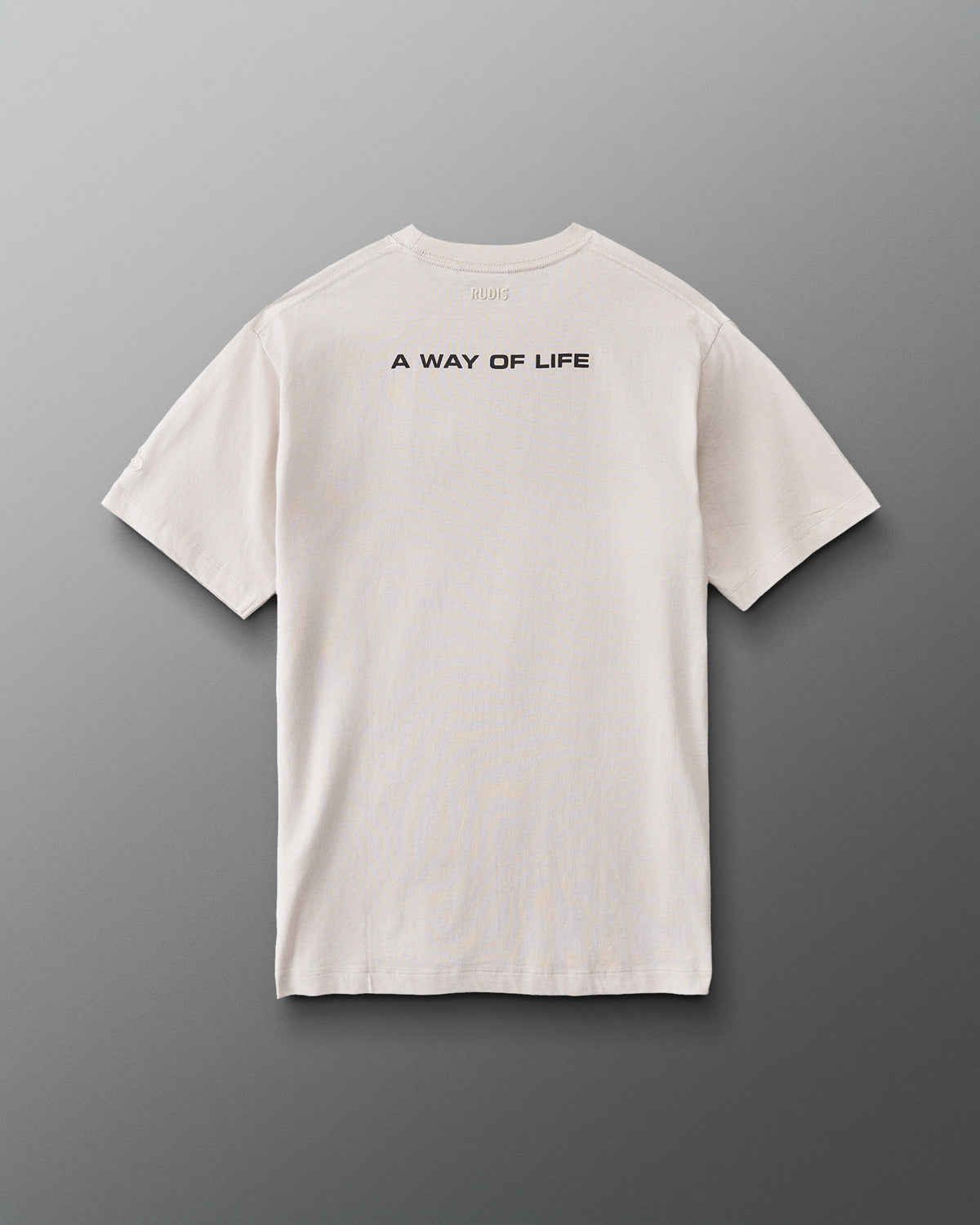 Back view of RUDIS Relaxed Cotton T-Shirt in Bone featuring black A WAY OF LIFE lettering across the upper back and subtle RUDIS neck branding.