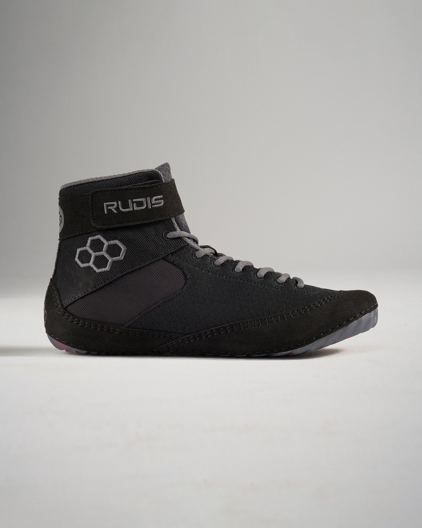 A modern black wrestling shoe featuring a high ankle design durable materials and a snug fit for optimal performance during competitive sports