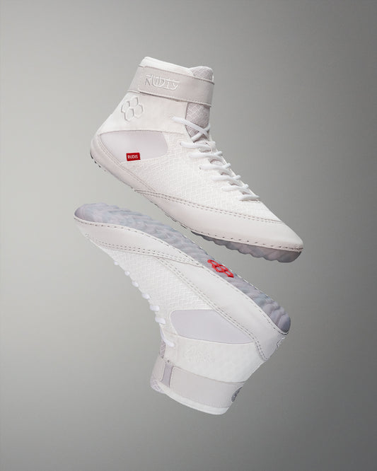 High-top wrestling shoe in an all-white design with red and gray accents, featuring a textured upper and padded collar for support and comfort.