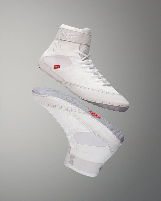 High-top wrestling shoe in an all-white design with red and gray accents, featuring a textured upper and padded collar for support and comfort.