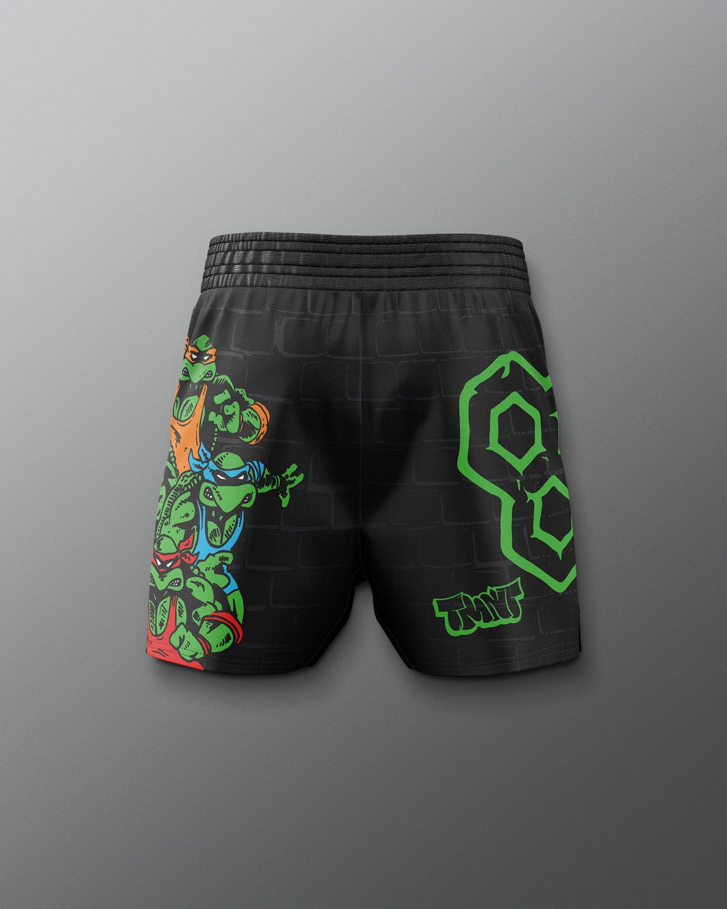 Black shorts with colorful graphic design on a gray background. TMNT. Teenage Mutant Ninja Turtle