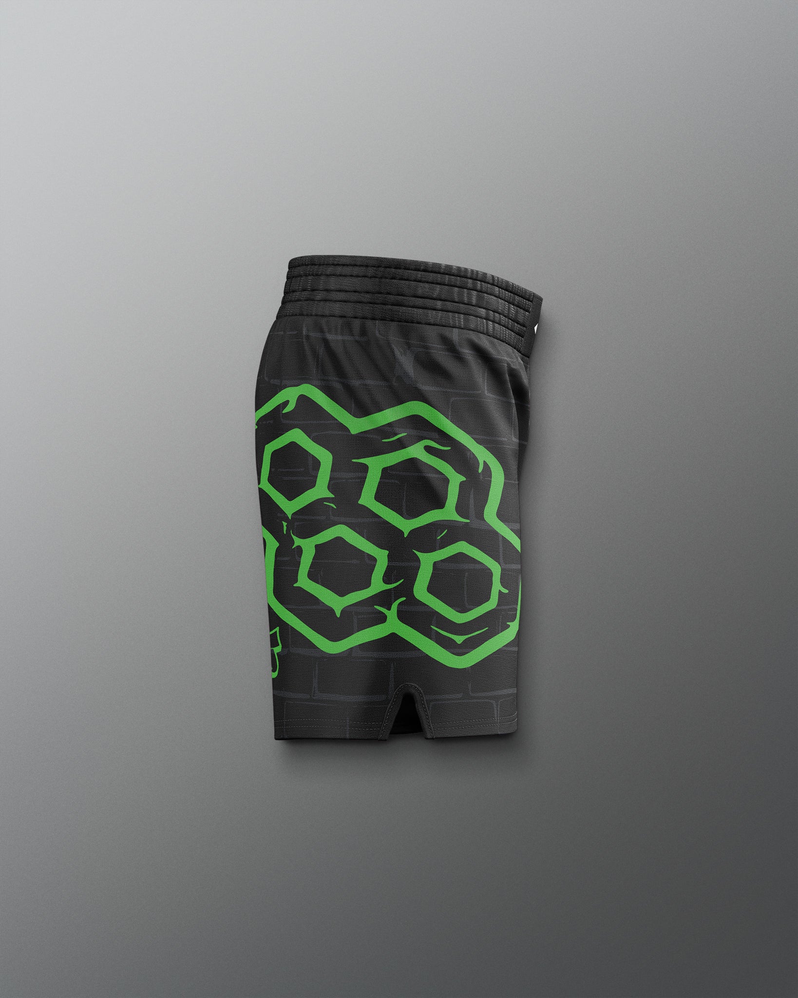 Black shorts with green geometric pattern on a gray background. TMNT. Teenage Mutant Ninja Turtle