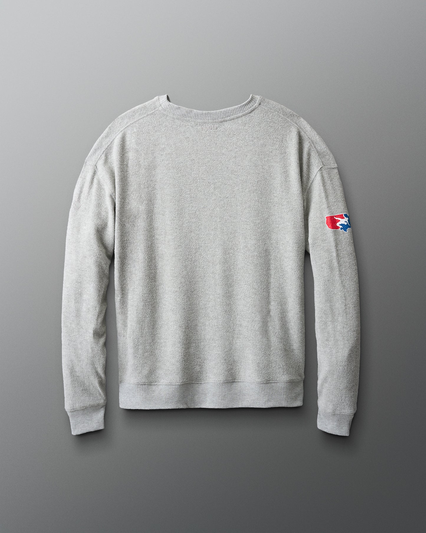 Gray sweatshirt with a logo on the sleeve against a gradient background