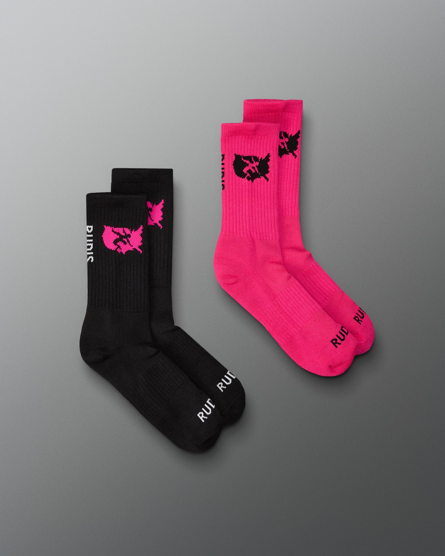 Two pairs of socks, one black and one pink, with a logo on a gray background.