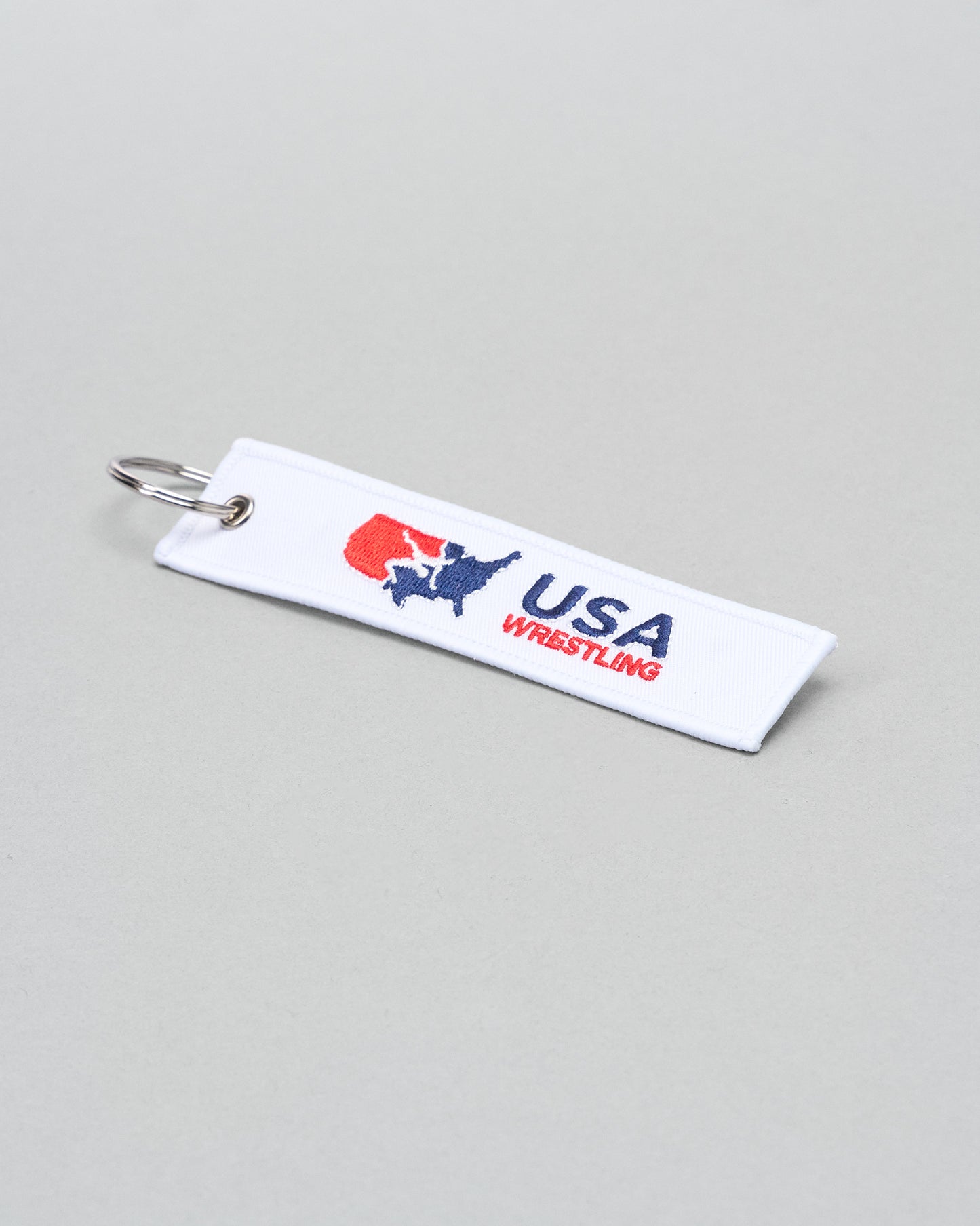 USA Wrestling keychain on a gray background