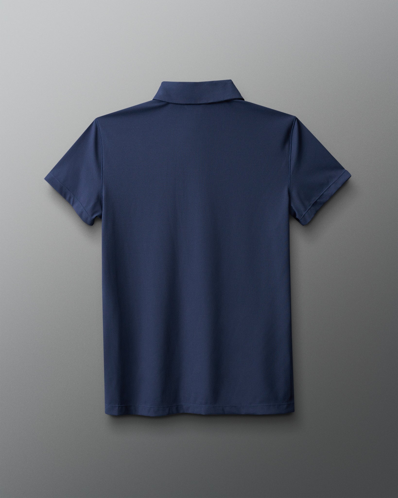 Navy blue polo shirt on a gray background