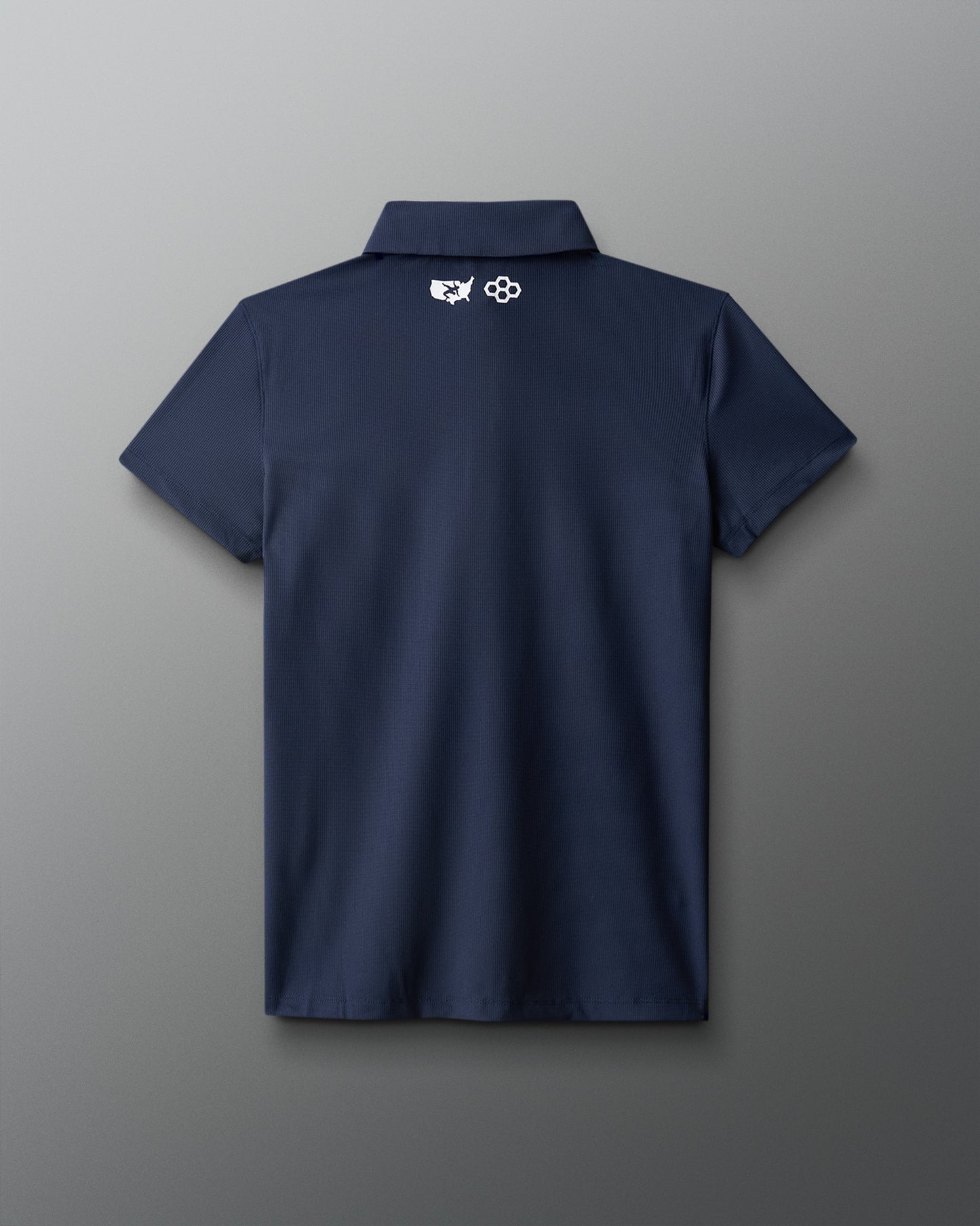 Navy blue polo shirt with a logo on the back against a gray background