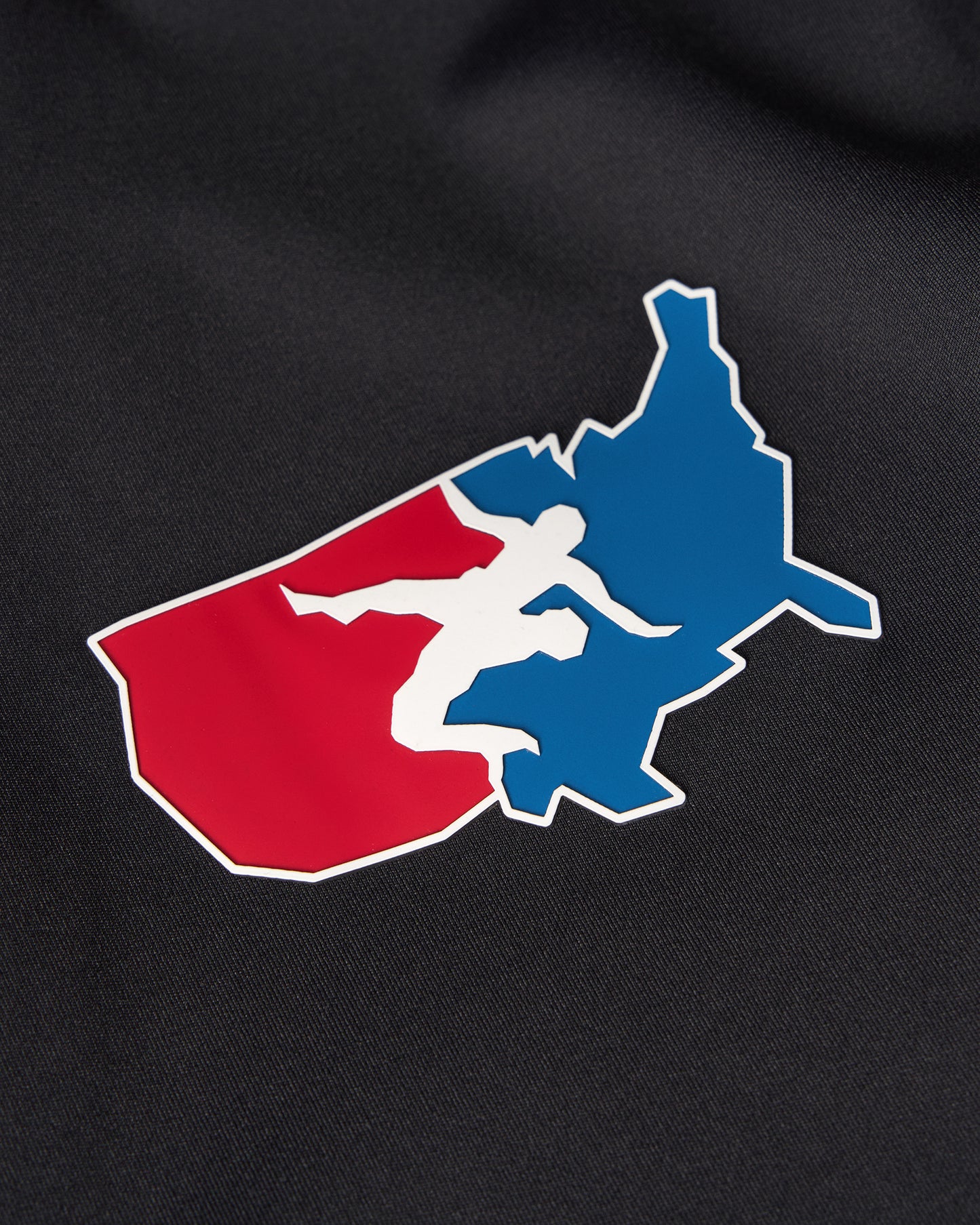 USA Wrestling Logo with a silhouette of a person in a red and blue shape on a black background
