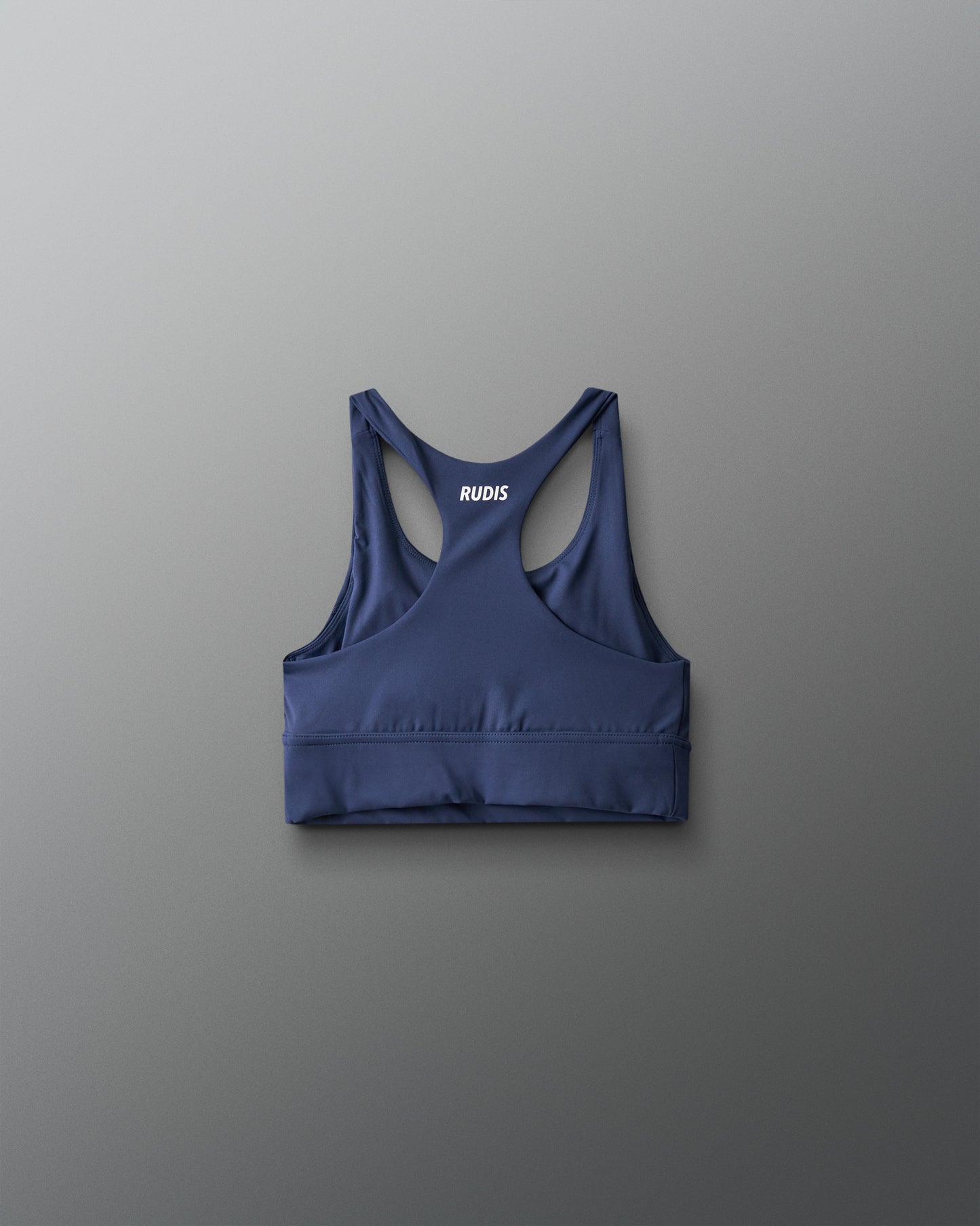 Blue sports bra with 'RUDIS' branding on a gray background