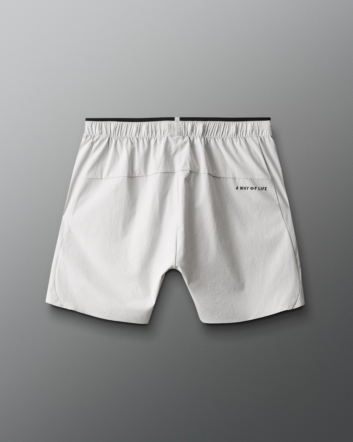 Light gray shorts with a brand logo on a gray background