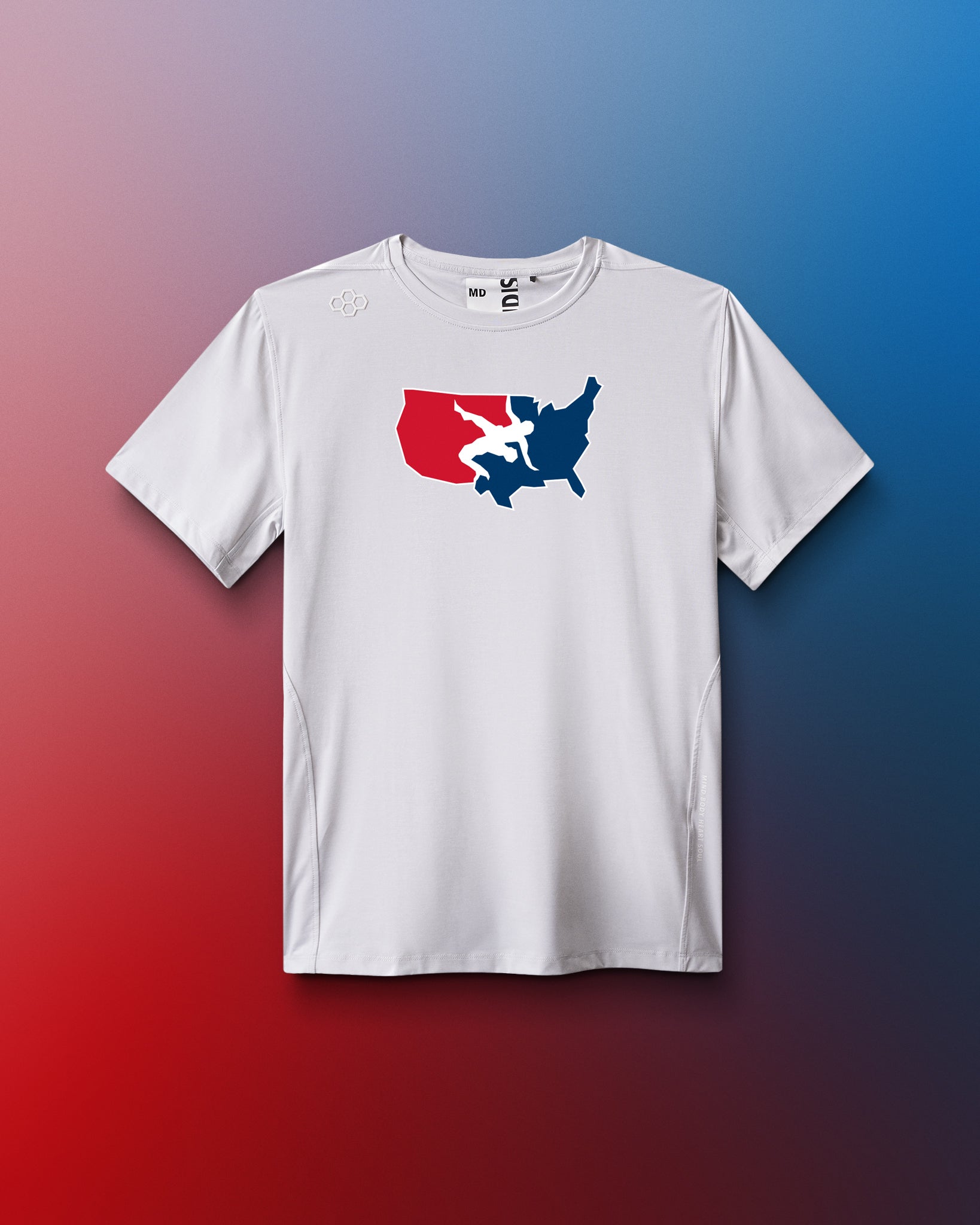 A white short-sleeve athletic T-shirt is displayed against a red-to-blue gradient background. Centered on the chest is a red, white, and blue USA Wrestling logo in the shape of the continental U.S., featuring two wrestlers in action. The shirt has a modern athletic fit.