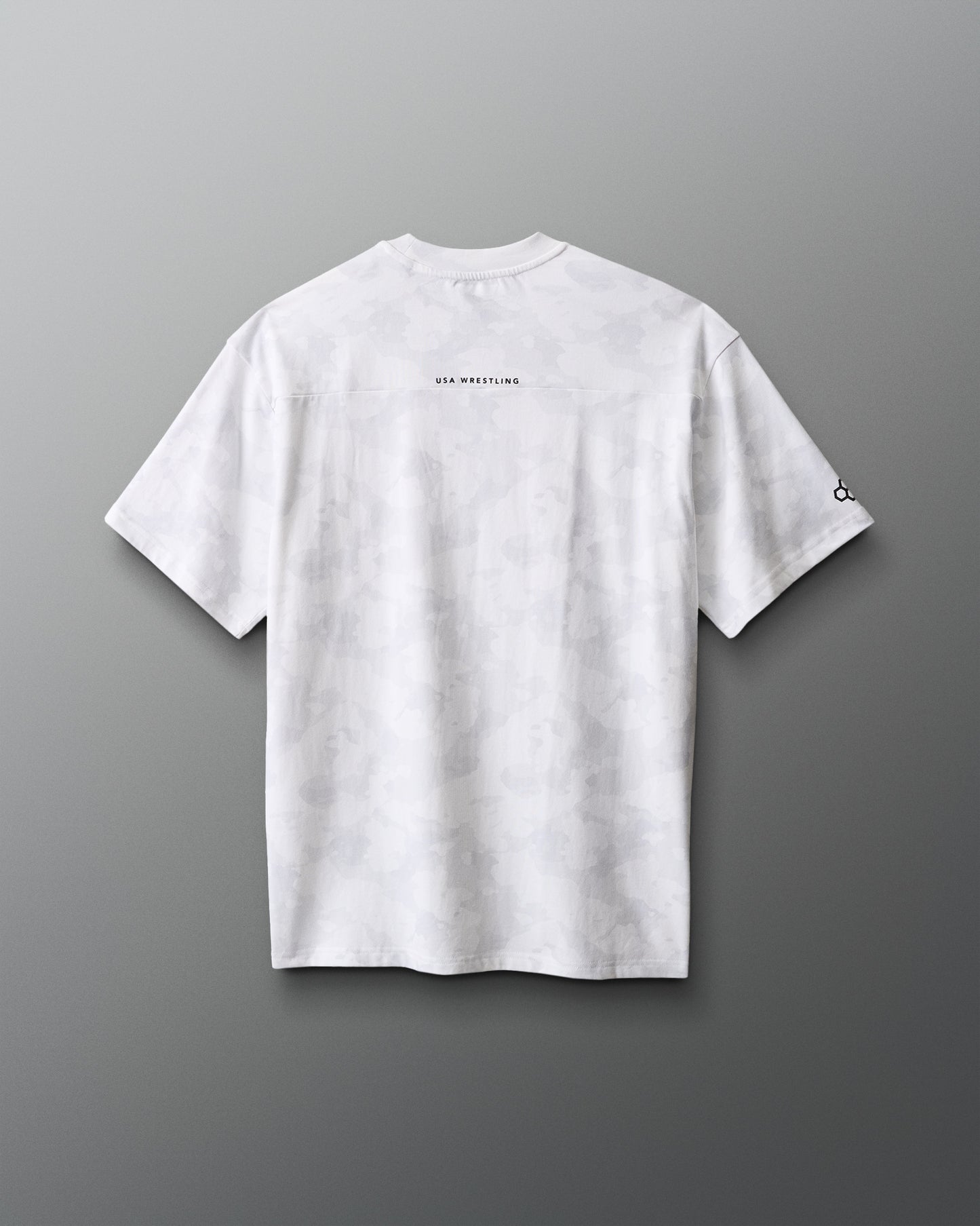 White t-shirt with text on the back against a gradient red to blue background