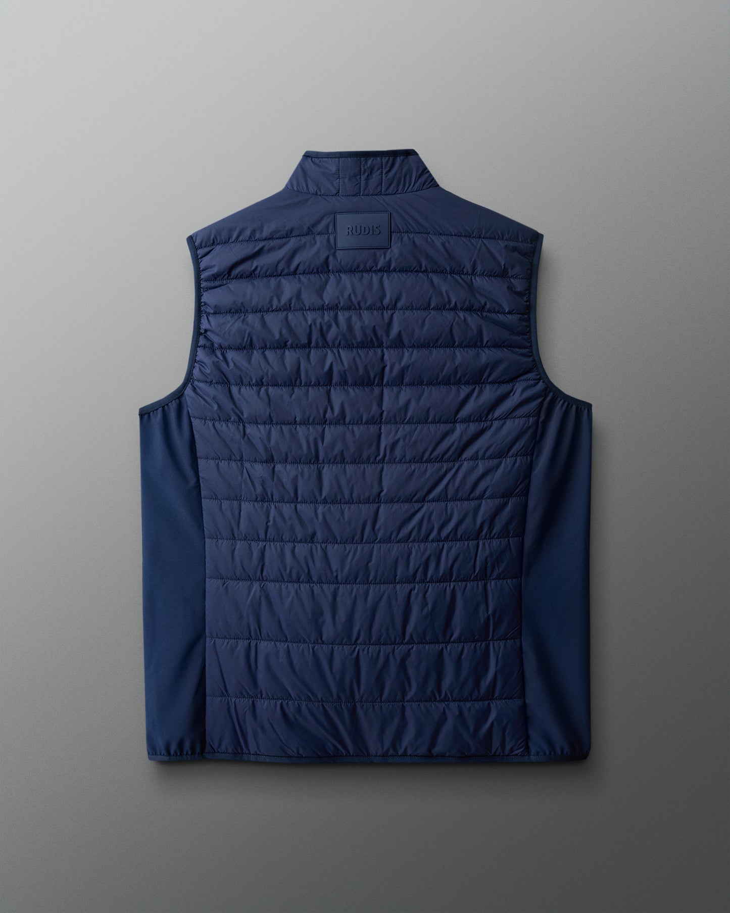 Black quilted vest on a gradient background