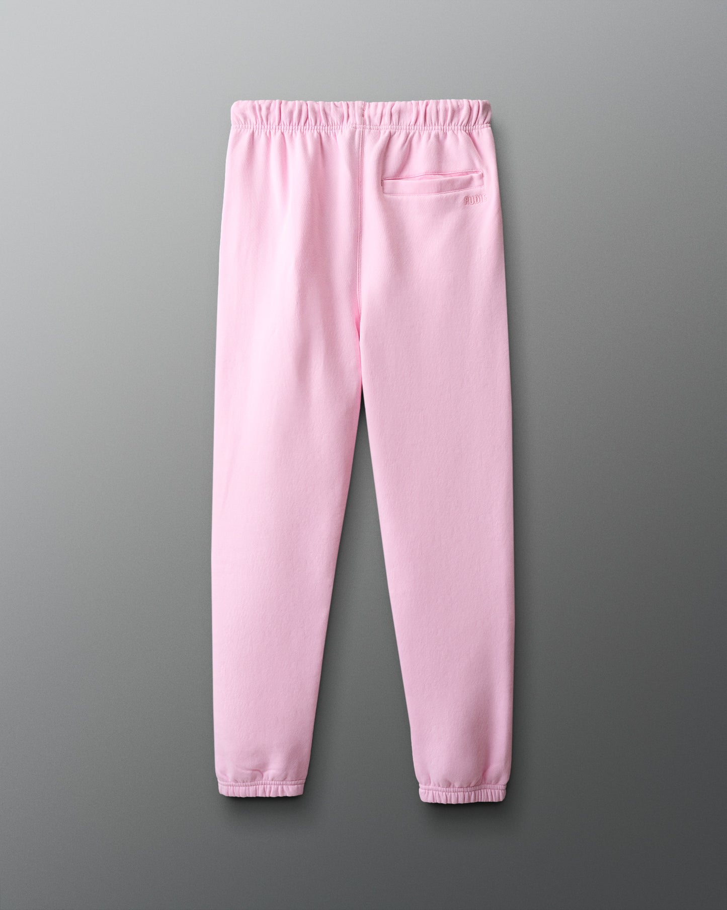 Pink sweatpants on a gray background