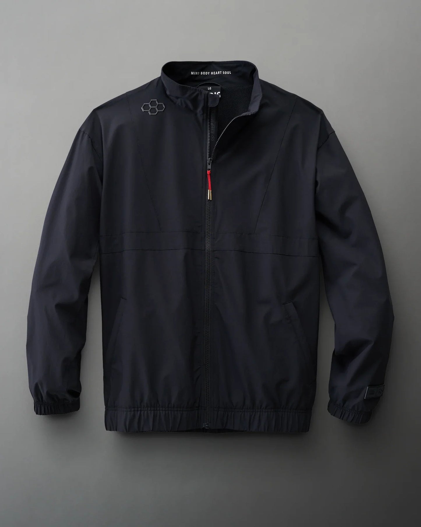 A black zip-up jacket with a high collar and subtle geometric design features elastic cuffs and waistband, suitable for outdoor activities.