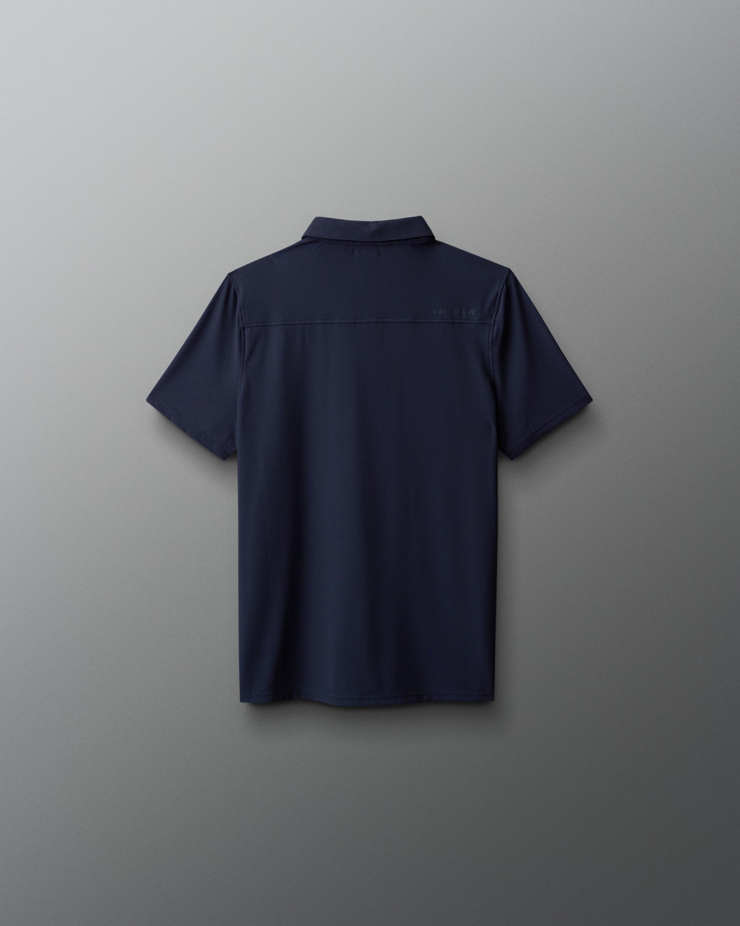 Navy blue polo shirt on a gray background
