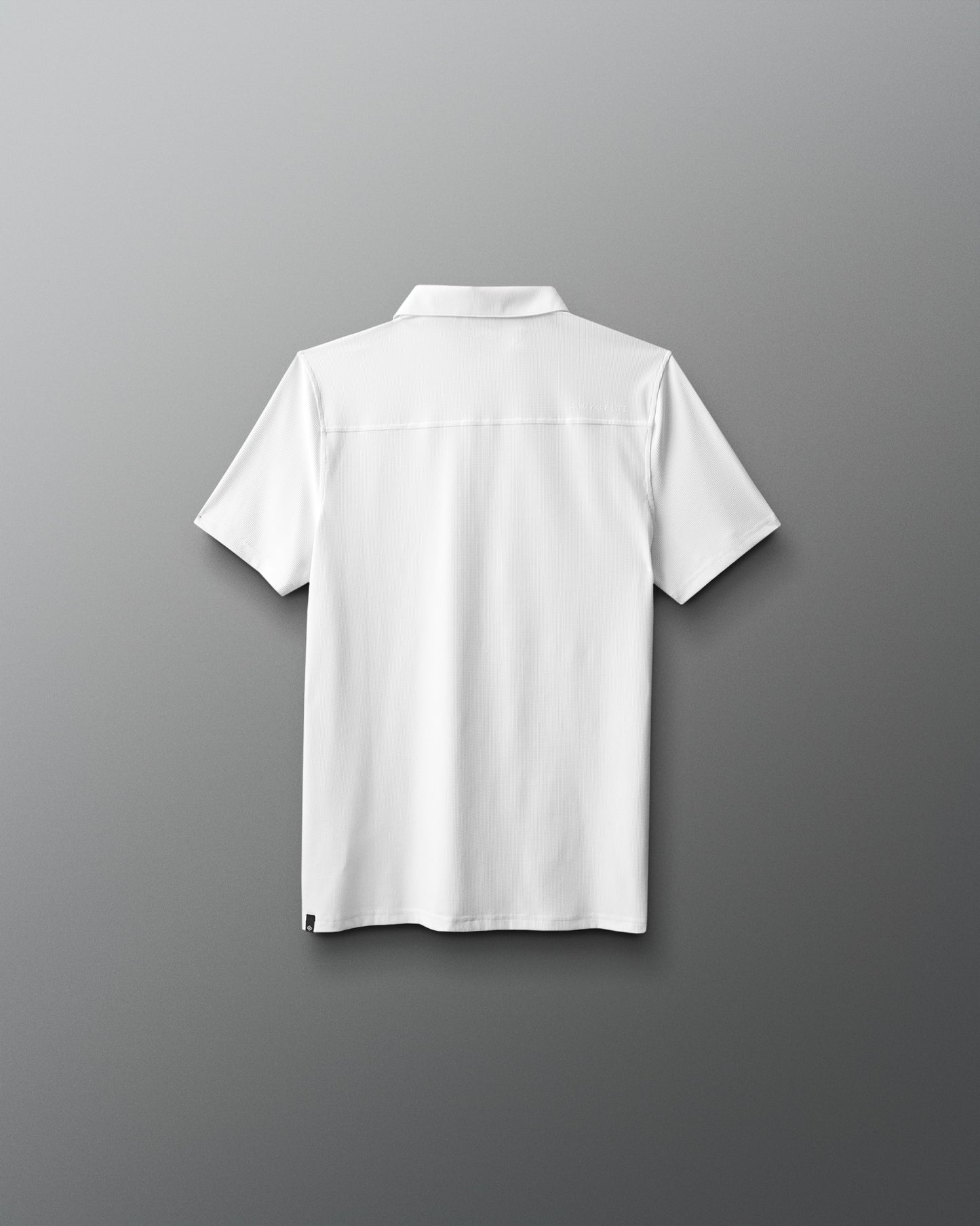 White polo shirt on a gray background