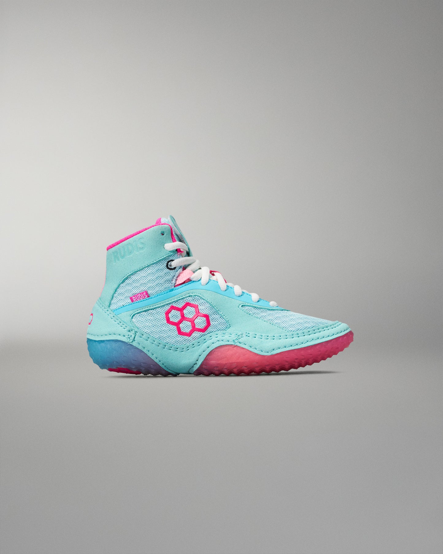 Turquoise and pink wrestling shoe on a gray background