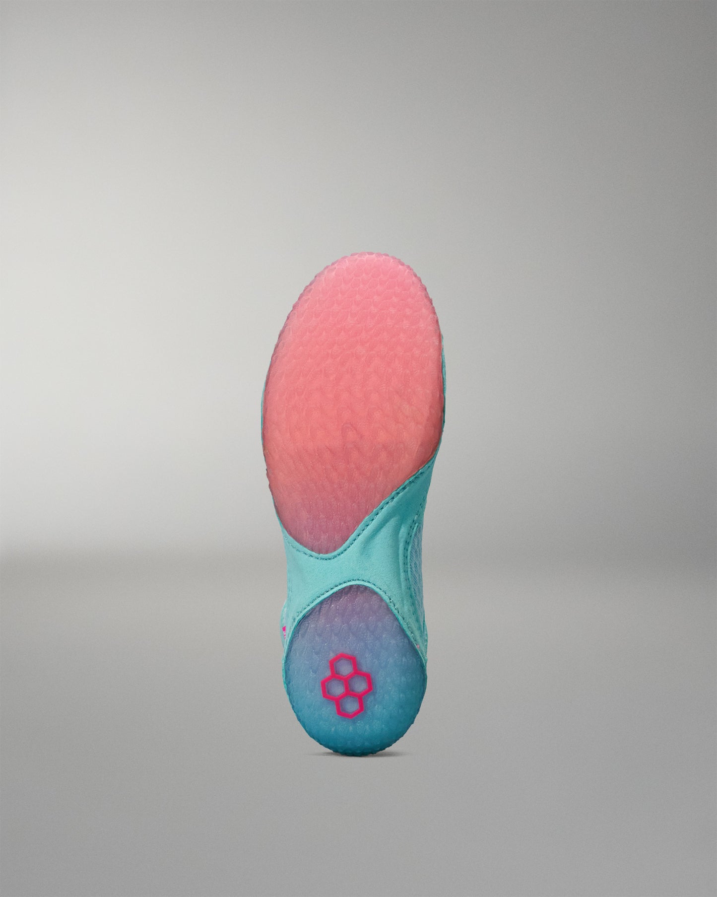 Teal and pink Wrestling Shoe sole on a gray background