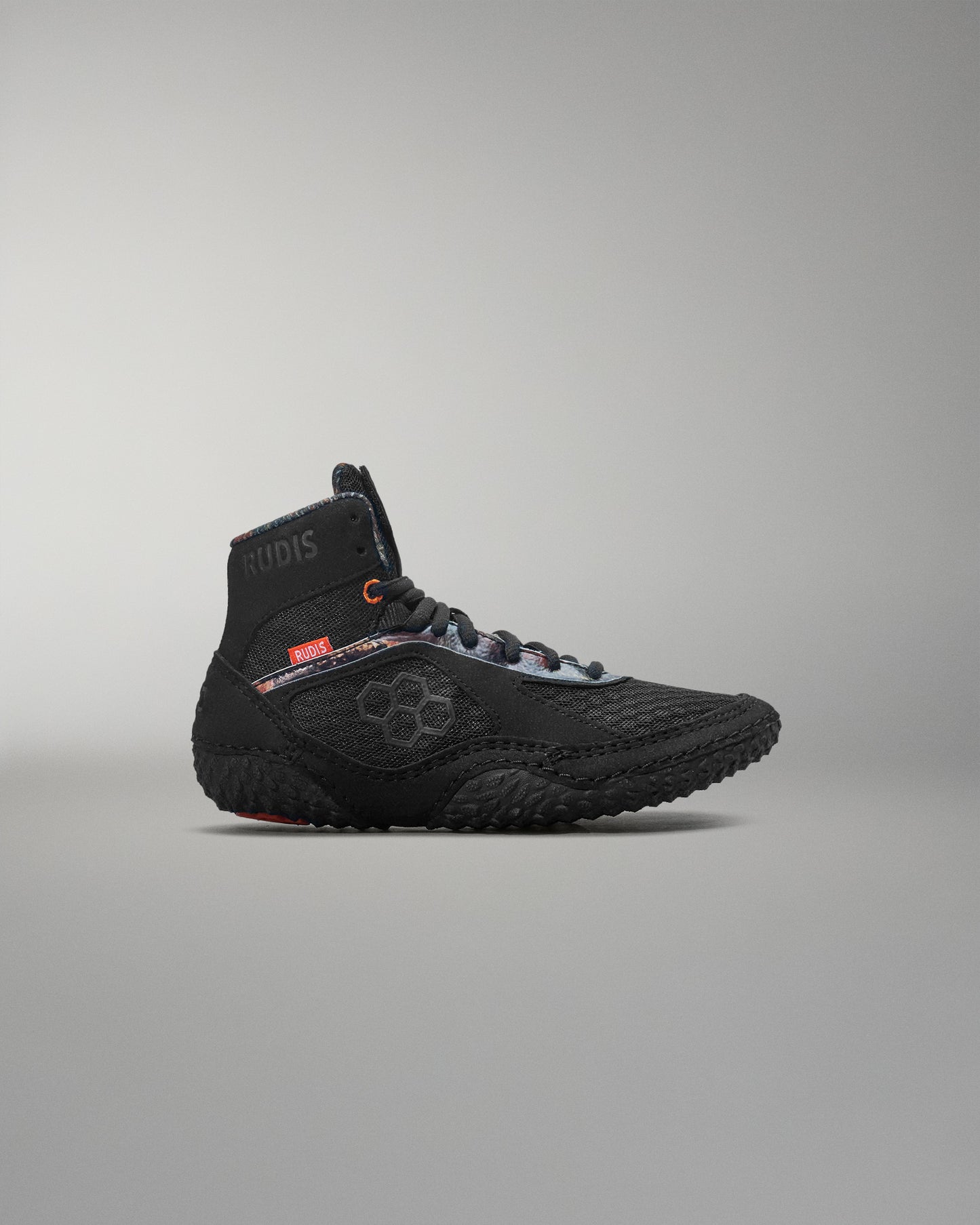 Black wrestling shoe on a gray background