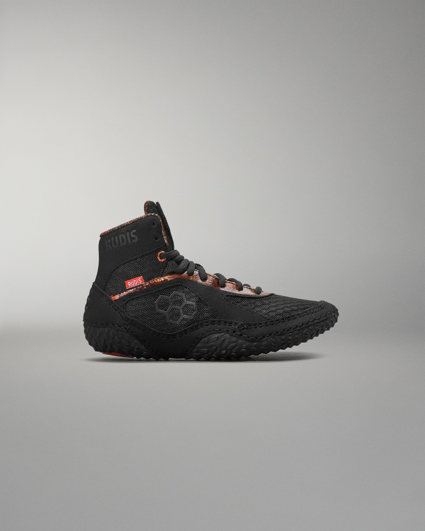 Black high-top sneaker on a gray background