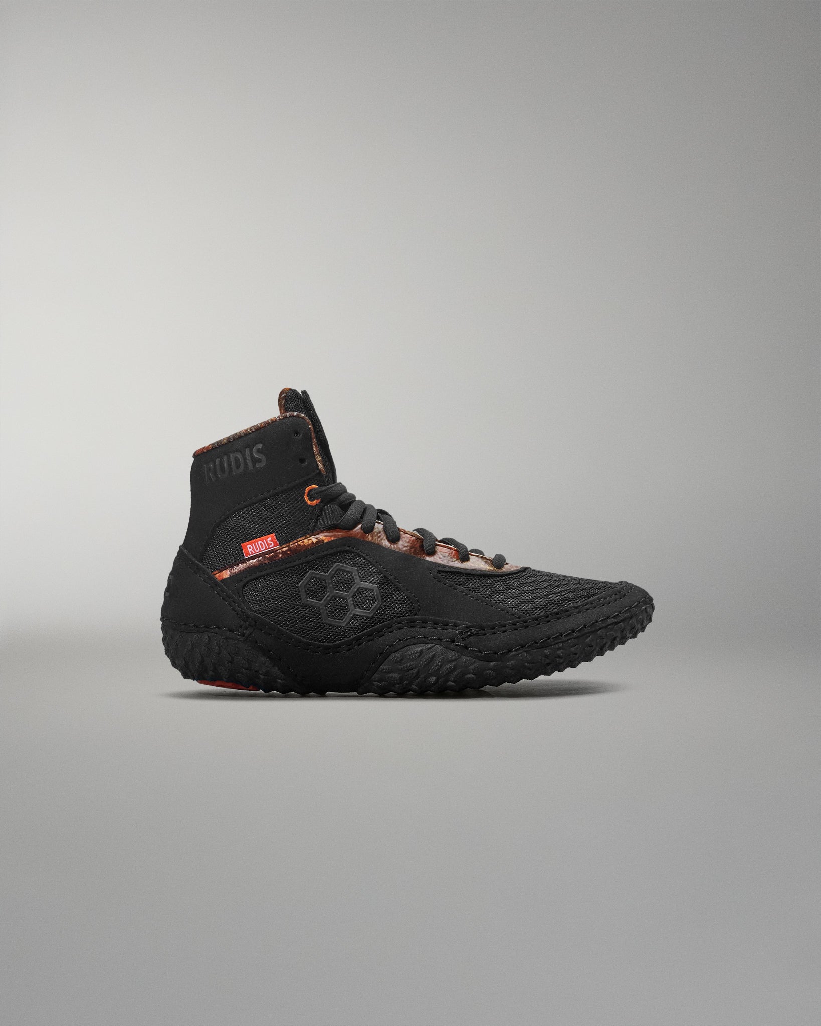 Black high-top sneaker on a gray background