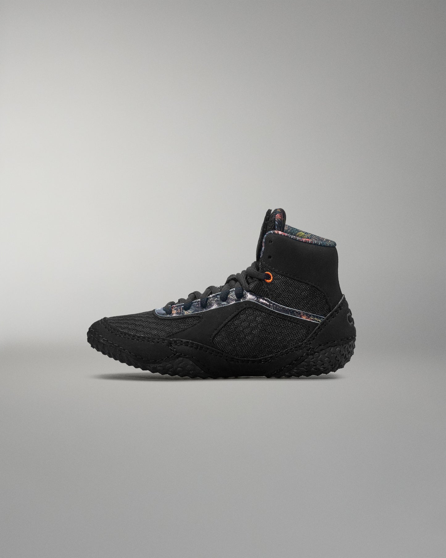 Black wrestling shoe on a gray background