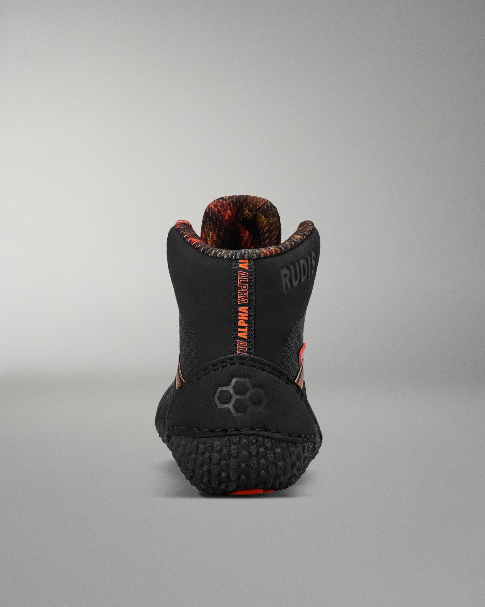 Black dog boot with red accents on a gray background