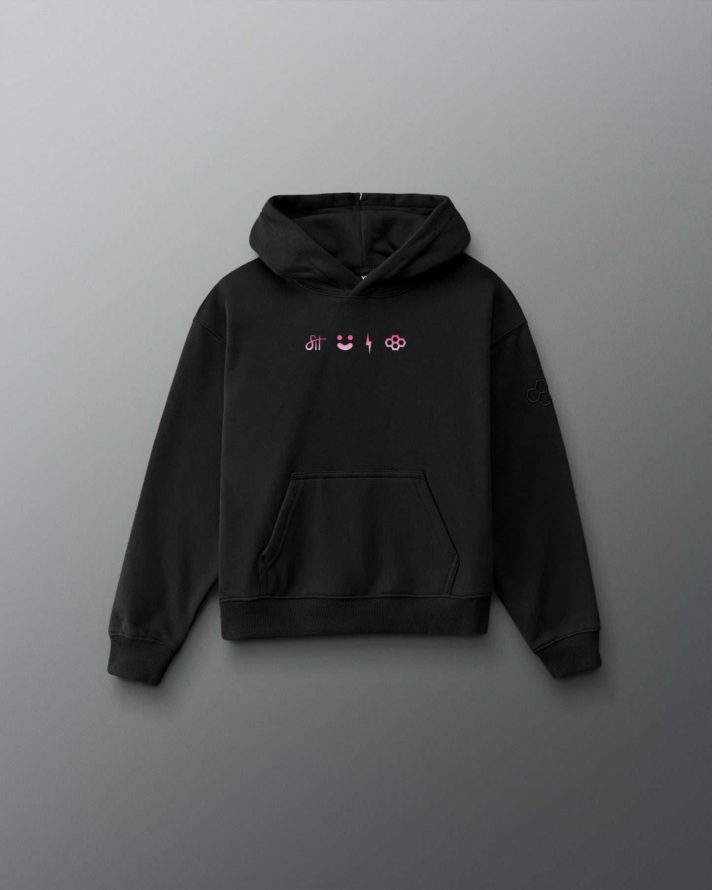 A black pullover hoodie with a small chest graphic featuring pink and white symbols, displayed against a dark gray gradient background.