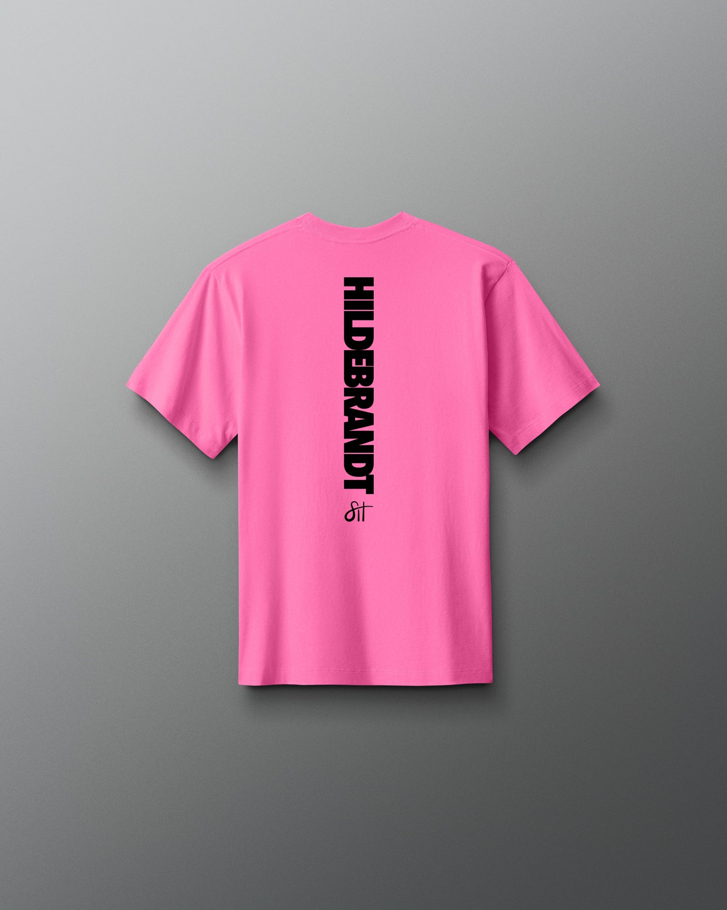 Pink t-shirt with 'Hilderbrandt' logo on the back against a gray background