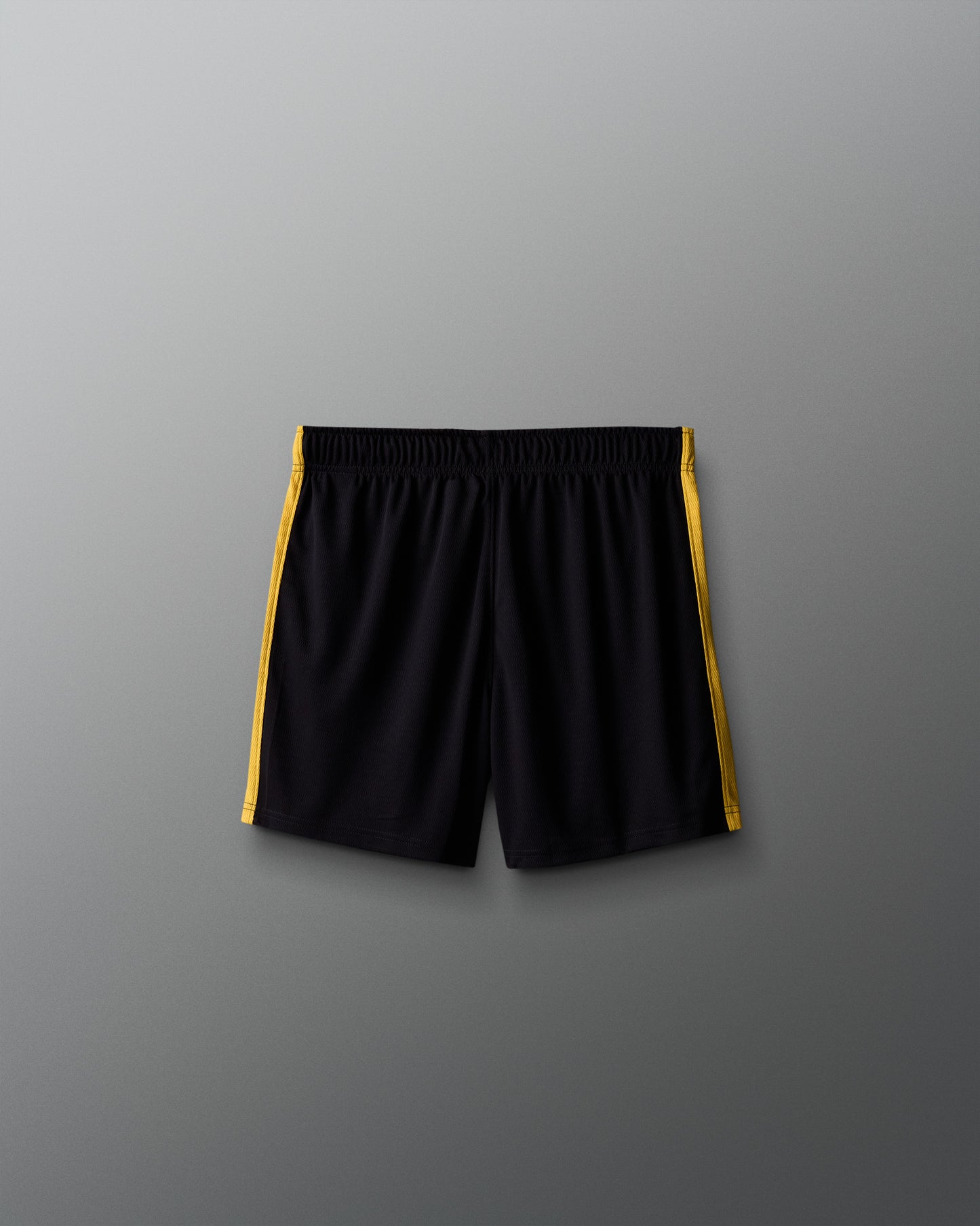 Black shorts with yellow accents on a gray background