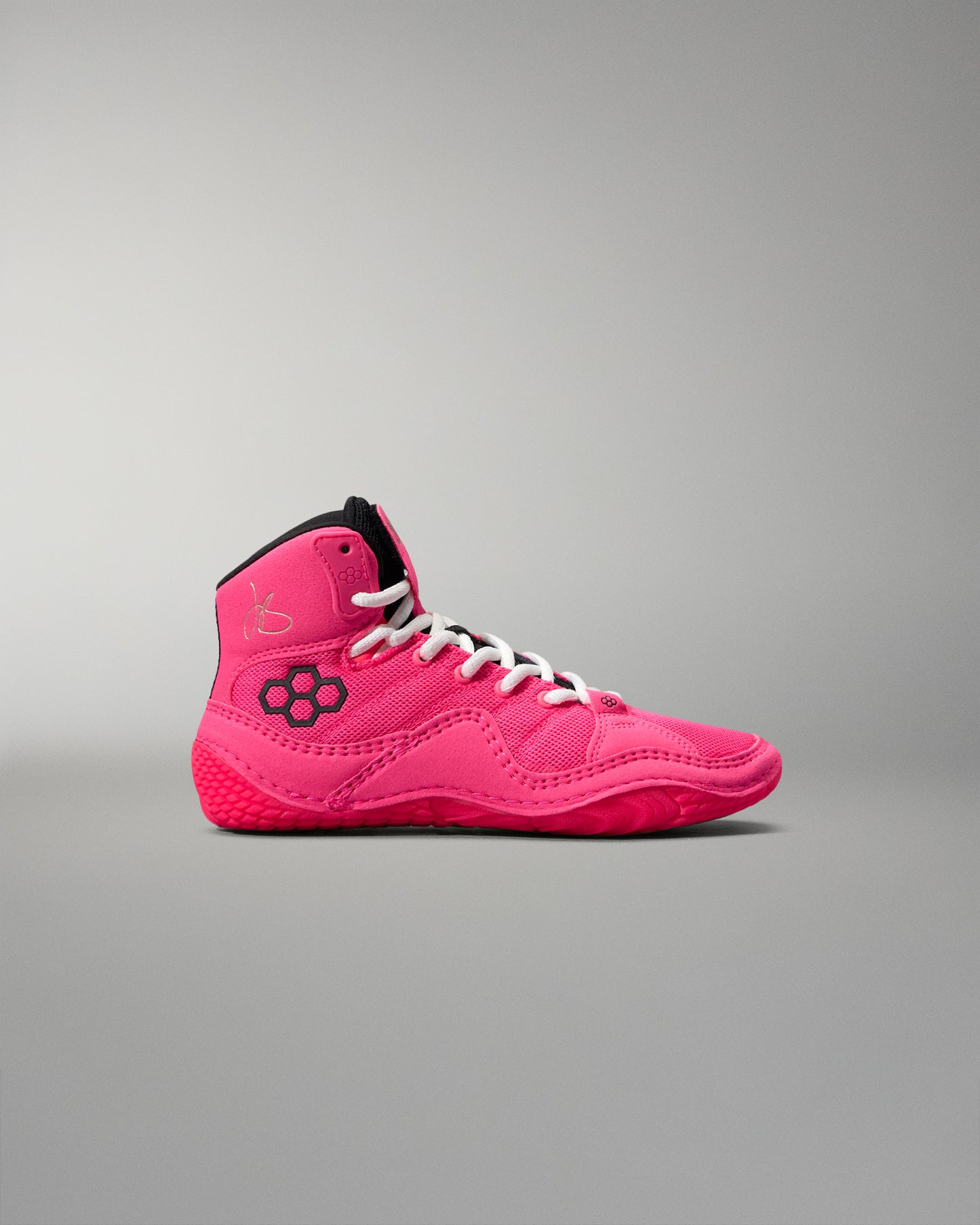 Pink high-top wrestling shoe on a gray background