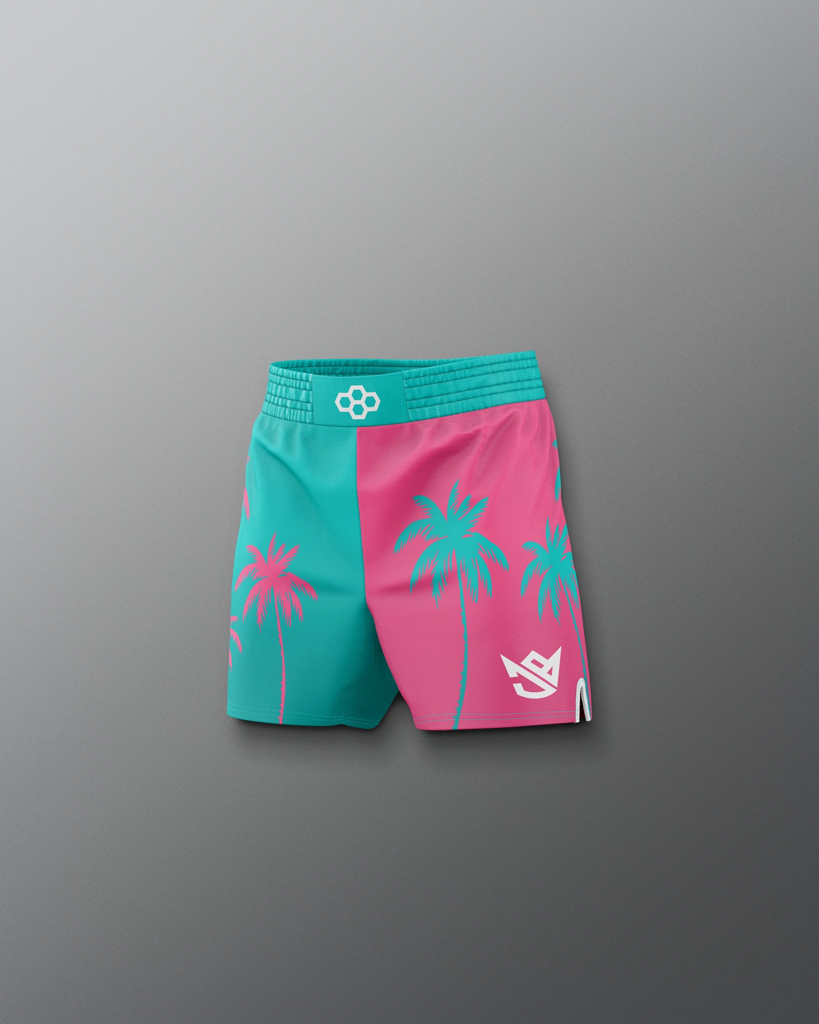Two-tone pink and teal shorts with palm tree designs on a gray background