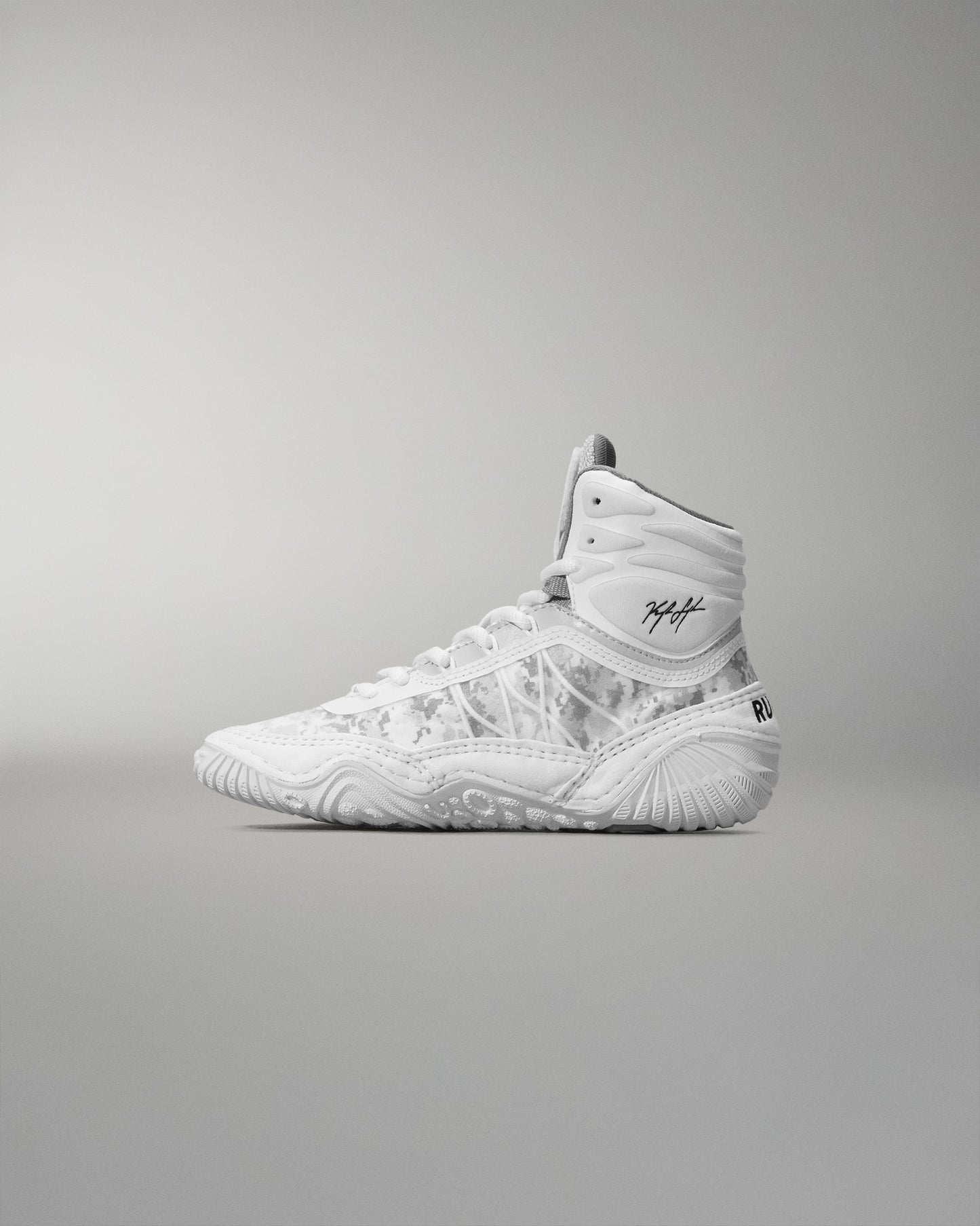 White high-top wrestling shoe on a gray background