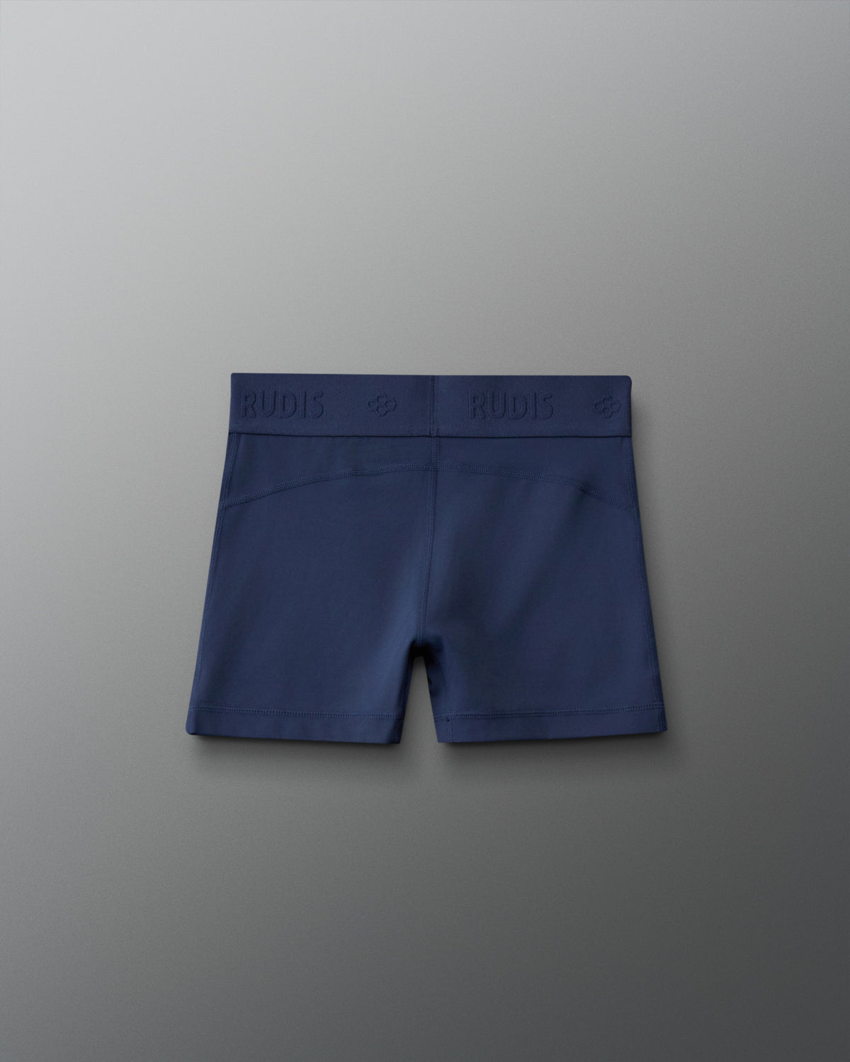 Back view of the RUDIS Girls Compression Short in Navy, highlighting the tonal RUDIS logo waistband, contoured rear stitching and fitted compression design.