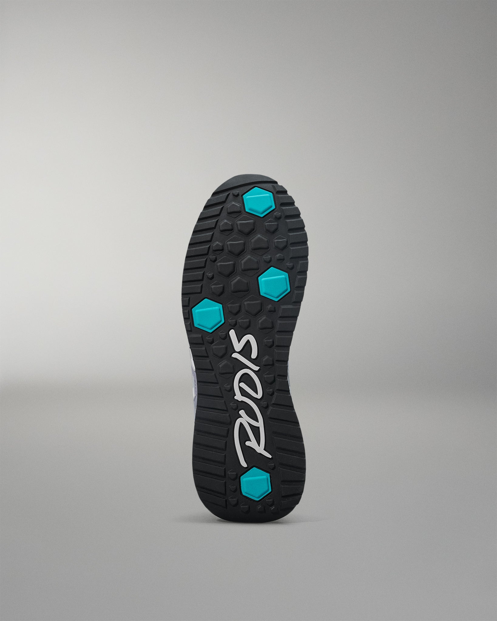 Black shoe sole with blue hexagonal patterns on a gray background