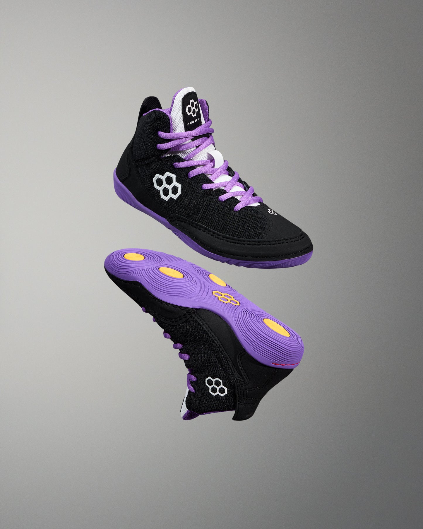 Black and purple high-top sneakers with yellow accents on a gray background