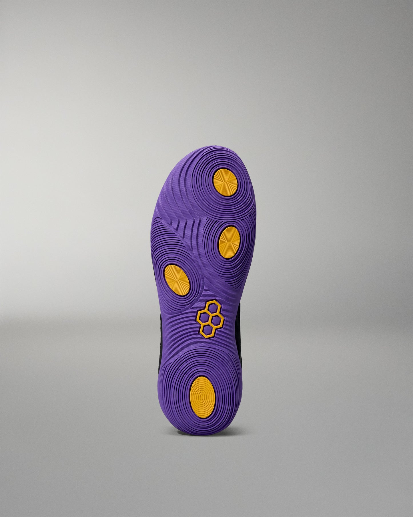 Purple shoe sole with yellow dots on a gray background