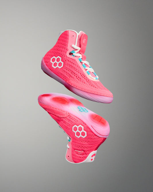 Pink girls wrestling shoes with a gray background