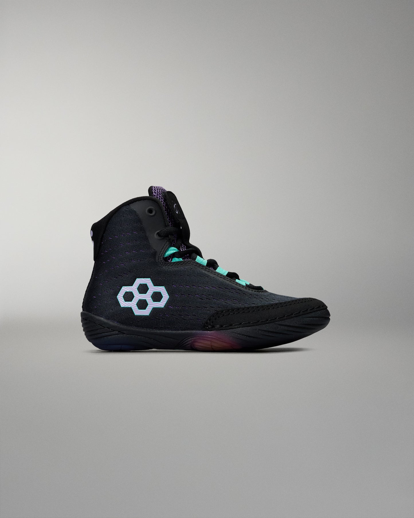 Black high-top sneaker with a white logo on a gray background