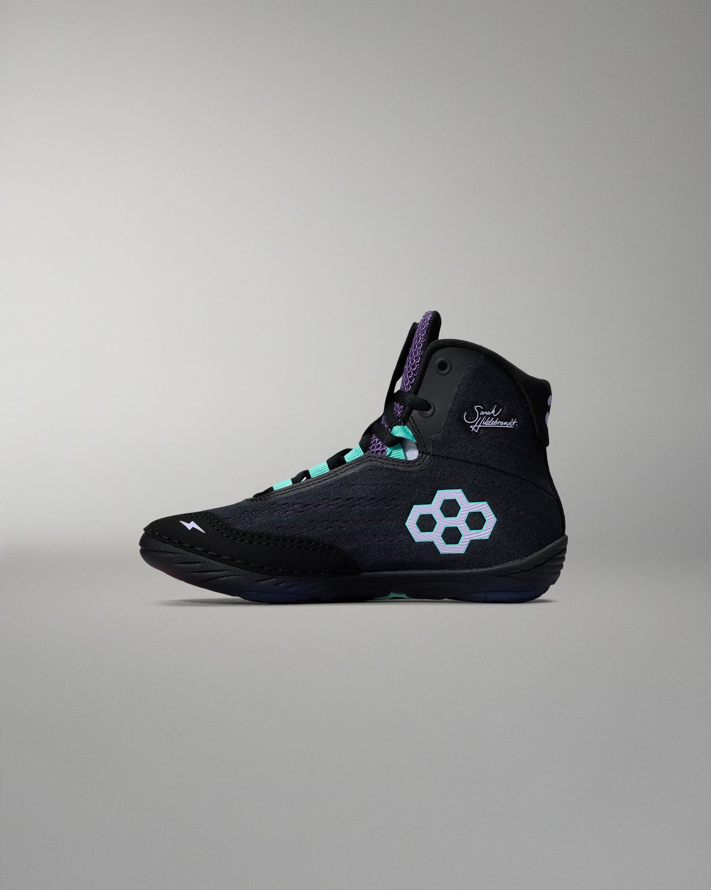 Black high-top sneaker with a white logo on a gray background