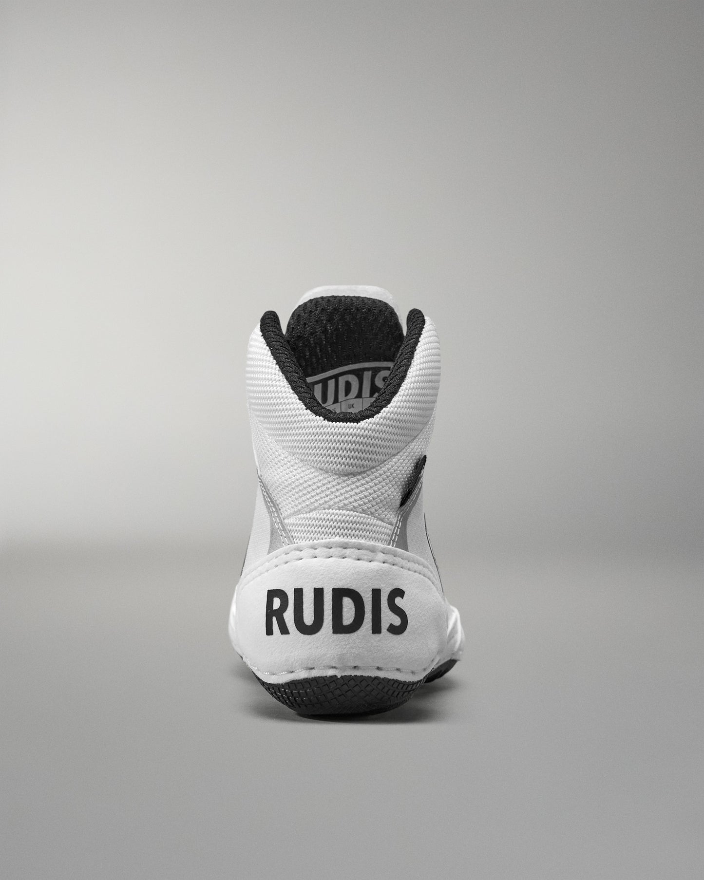 White Wrestling Shoe with black sole and 'RUDIS' branding on a gray background