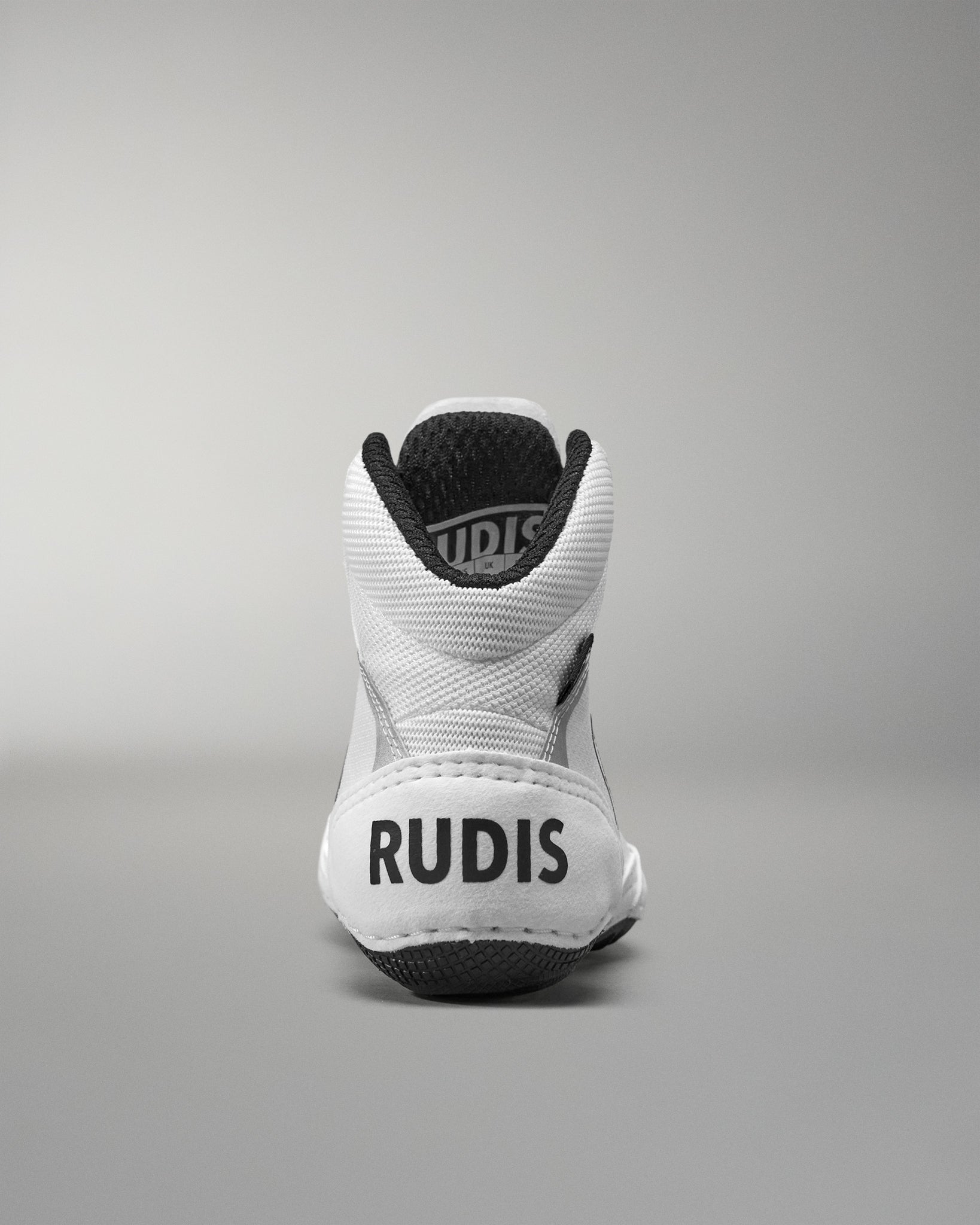 White Wrestling Shoe with black sole and 'RUDIS' branding on a gray background
