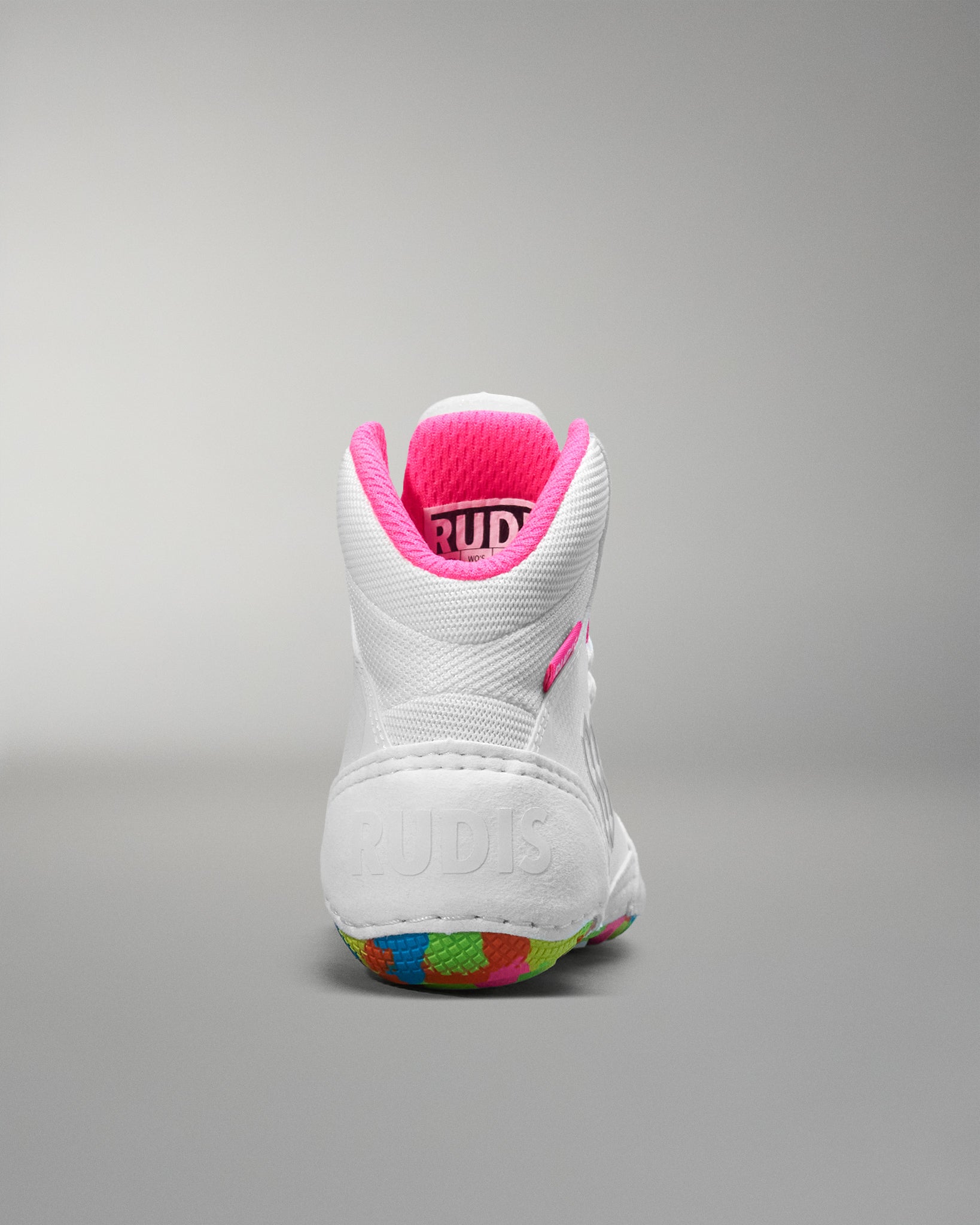 White wrestling shoe with pink interior on a gray background