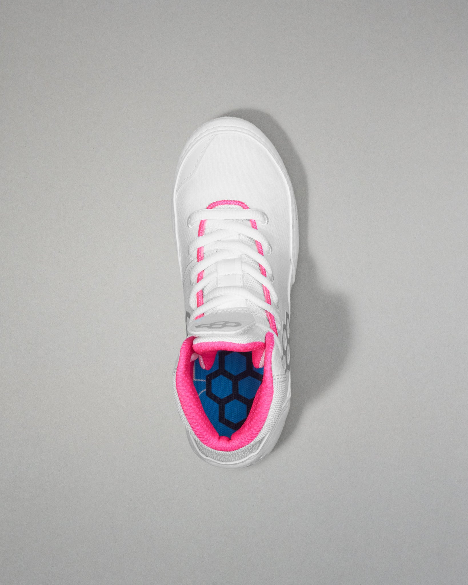 White wrestling shoe with pink accents on a gray background